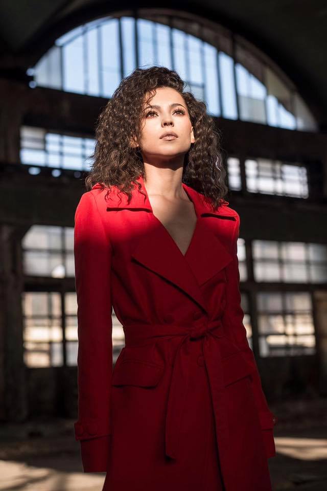 AMI wearing OMRA red cotton trench in her music video